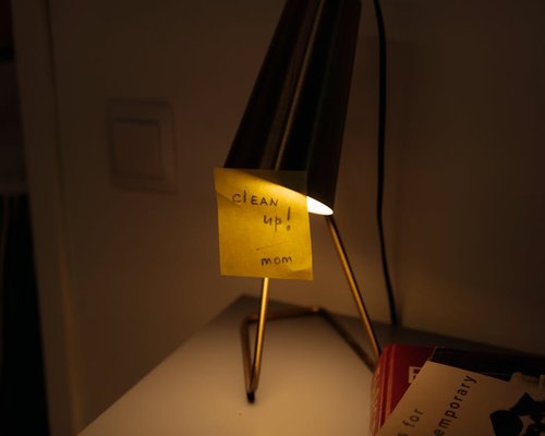 Desk lamp casting warm light on a notebook