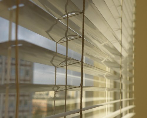 Window blinds partially closed to block direct sunlight